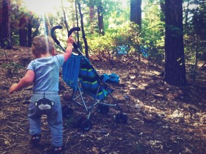 Gabriel pushing the stroller in the forest